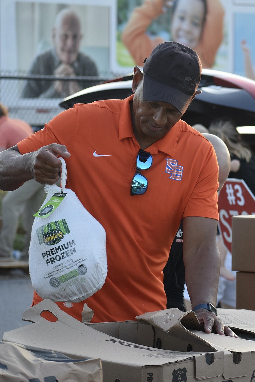 Phil Bradley lifts a turkey.