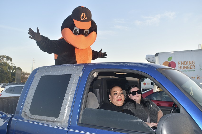 The Oriole Bird hitches a ride atop the vehicle of Marisa Enis and Kayla McCarty.