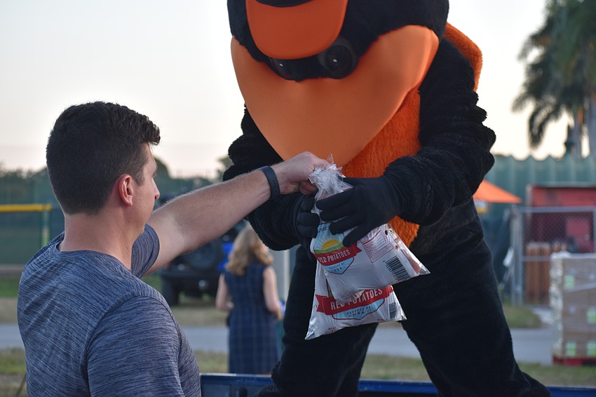 Brian Parreira helps The Oriole Bird load potatoes.