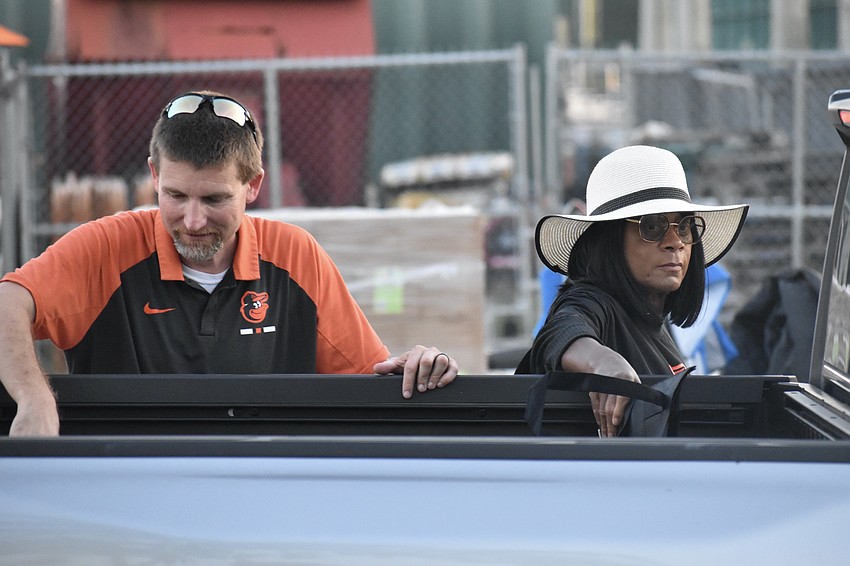 Scott Stansbury and Linda Jones load supplies into a trunk.