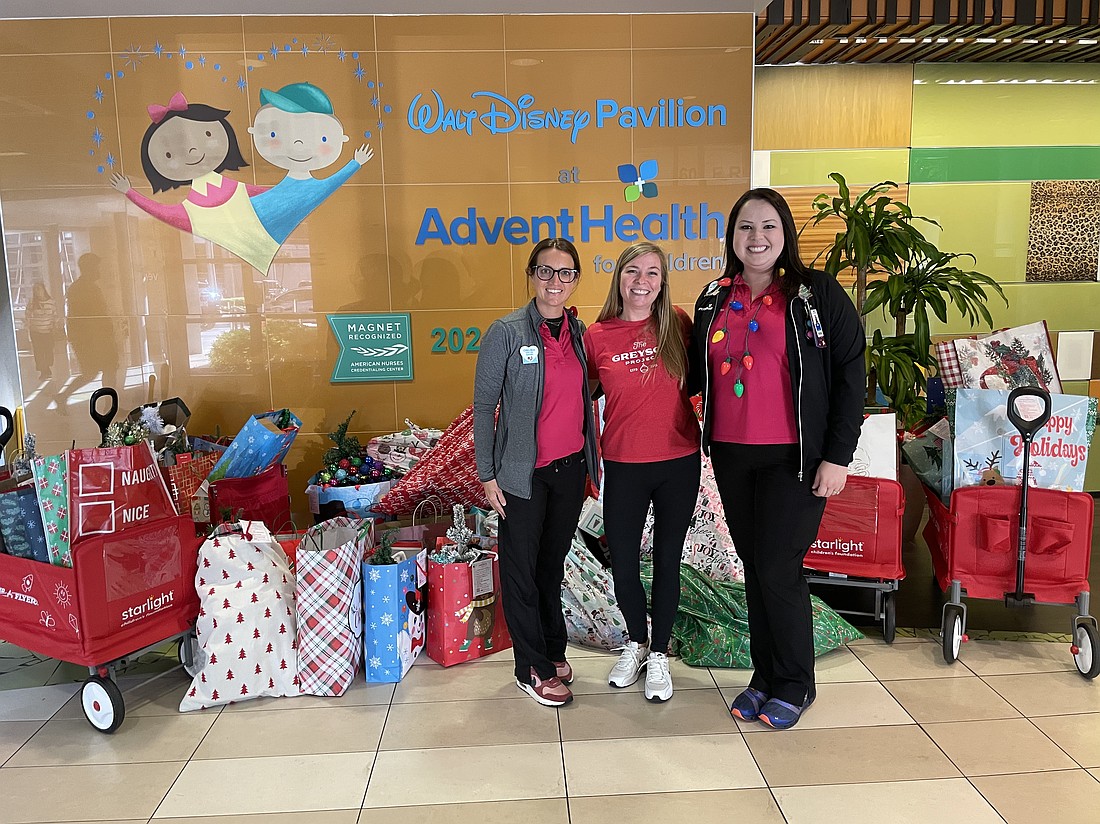 For the past 11 years, Rene Porter, founder of The Greyson Project, center, has been delivering bags filled with Christmas decorations to hospitals such as AdventHealth.