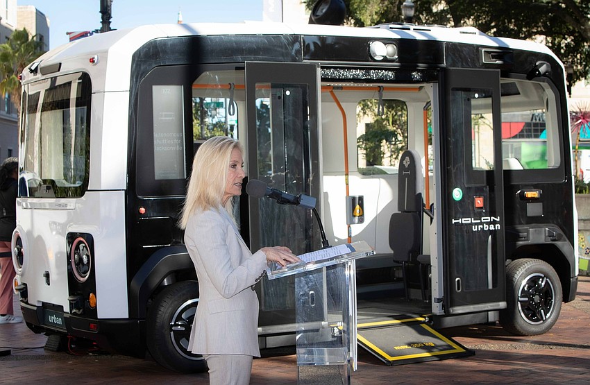 Jacksonville Mayor Donna Deegan speaks in front of a Holon vehicle planned to replace the Ford vans now used for NAVI. German vehicle maker Holon plans to build a $100 million, 500,000-square-foot manufacturing plant in North Jacksonville.