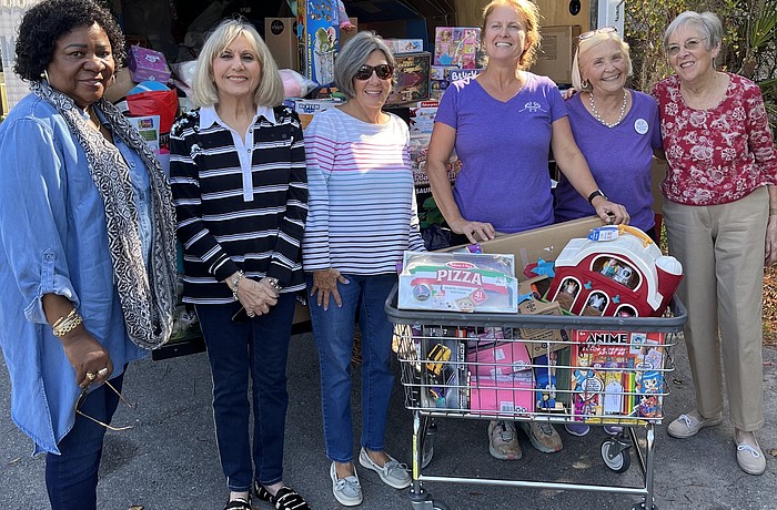 Mission in Motion's Ruth Barker, Rose Marie Hartley, Faith Michael, Mothers Helping Mothers director of donations Barbara Braun, Debbie Apple and Judy Kirkpatrick fill a truck with toy donations.