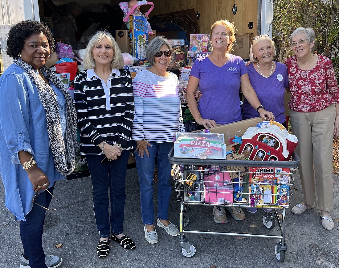 Mission in Motion's Ruth Barker, Rose Marie Hartley, Faith Michael, Mothers Helping Mothers director of donations Barbara Braun, Debbie Apple and Judy Kirkpatrick fill a truck with toy donations.