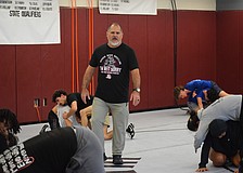 Coach Cezar Sharbono talks his players through drills during practice. He's entering his sixth season at the helm of the Braden River wrestling program.