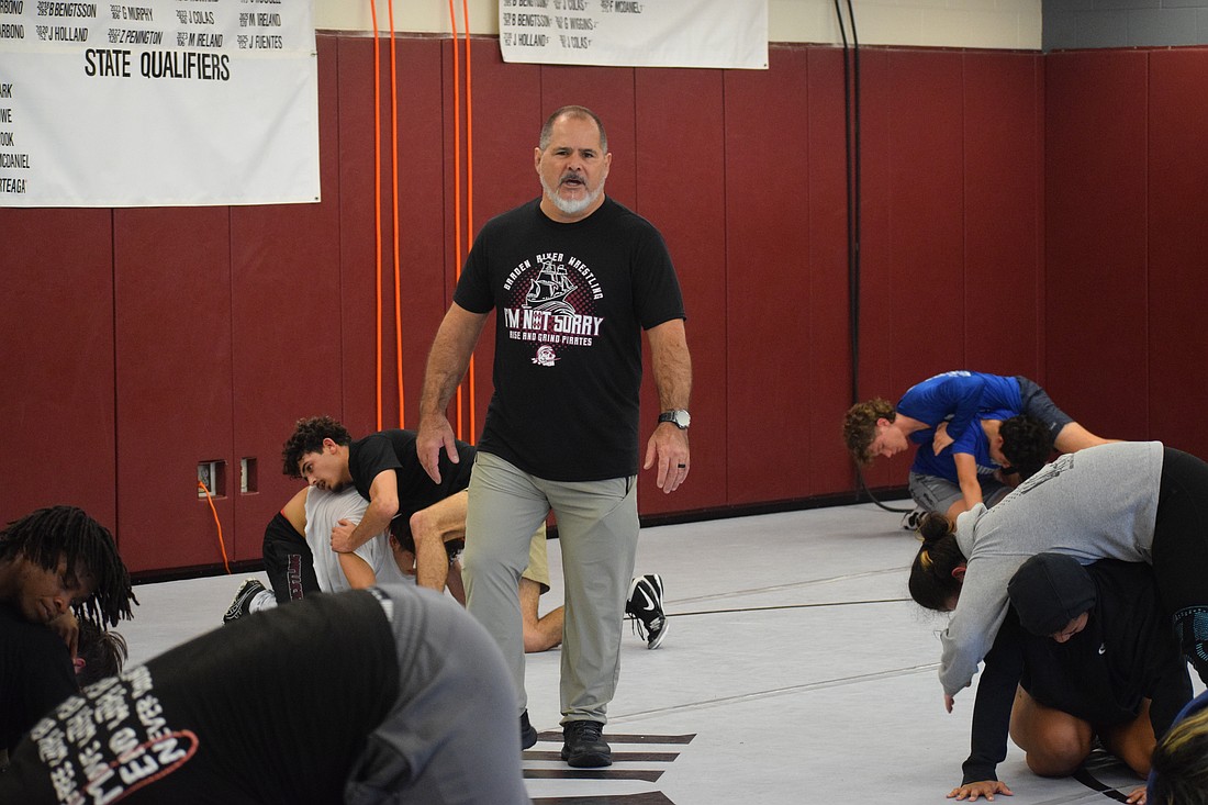 Coach Cezar Sharbono talks his players through drills during practice. He's entering his sixth season at the helm of the Braden River wrestling program.