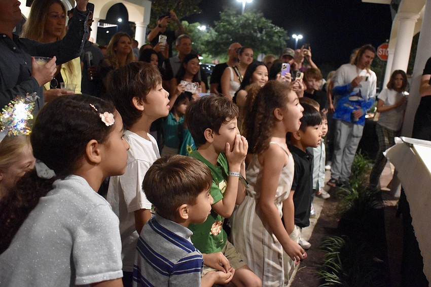 The crowd is thoroughly entertained by the tuna cutting ceremony.