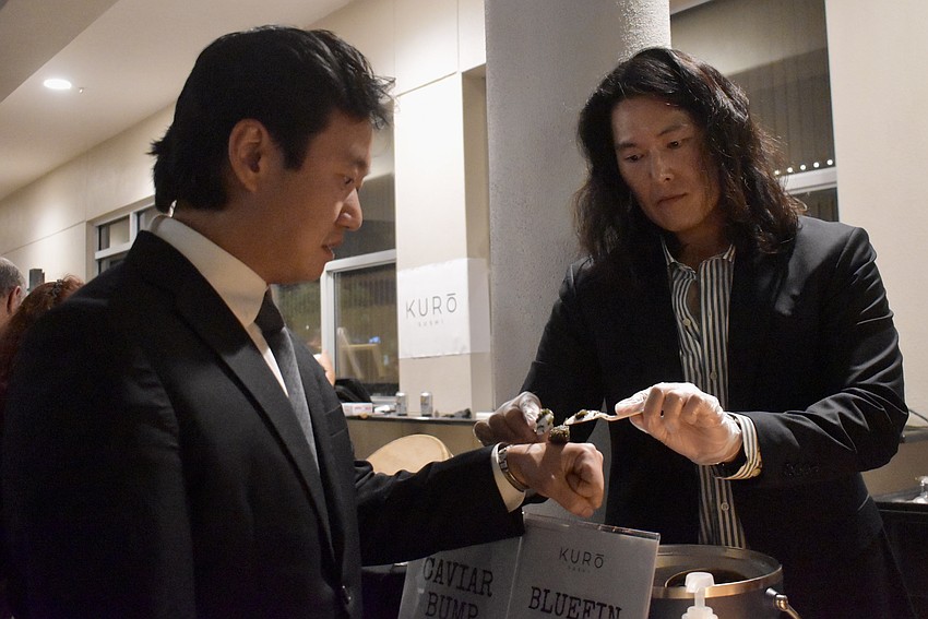 Kore Steakhouse Chef Clark Jinsung Park places caviar on Daniel Dokko's hand. It's called a 