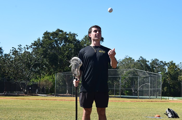 Vinny Mercadante tosses a lacrosse ball and holds his stick at Summerfield Community Park in Lakewood Ranch. He played for Cardinal Mooney in 2016-18, Marian University in 2018-19 and Florida State in 2021-23 but has since committed to coaching.