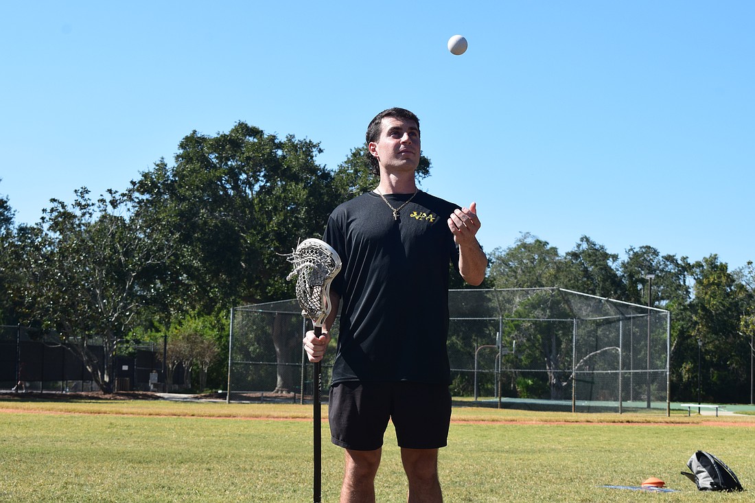 Vinny Mercadante tosses a lacrosse ball and holds his stick at Summerfield Community Park in Lakewood Ranch. He played for Cardinal Mooney in 2016-18, Marian University in 2018-19 and Florida State in 2021-23 but has since committed to coaching.