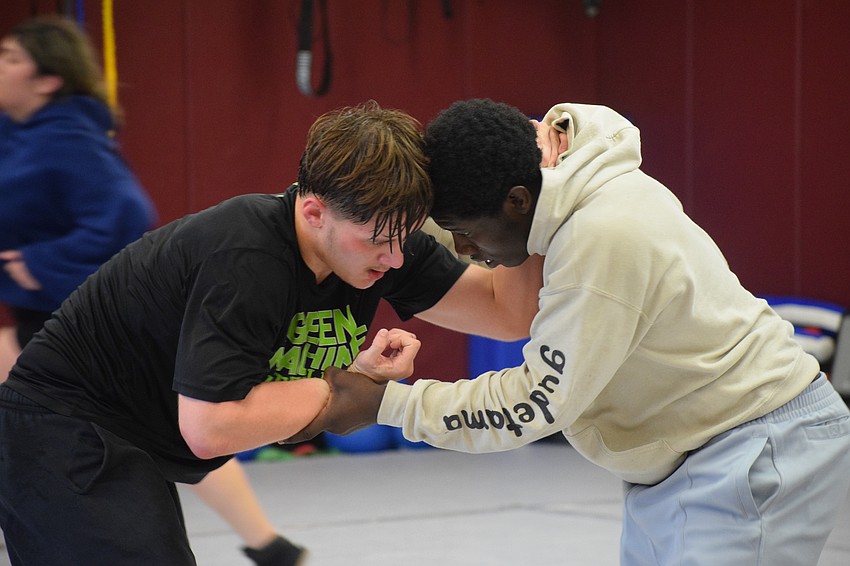 Juniors Logan Pike (left) and Freedom McDaniel (right) tussle during a Nov. 21 practice. They'll compete in the 190- and 215-pound weight classes, respectively, for the 2025-26 season.