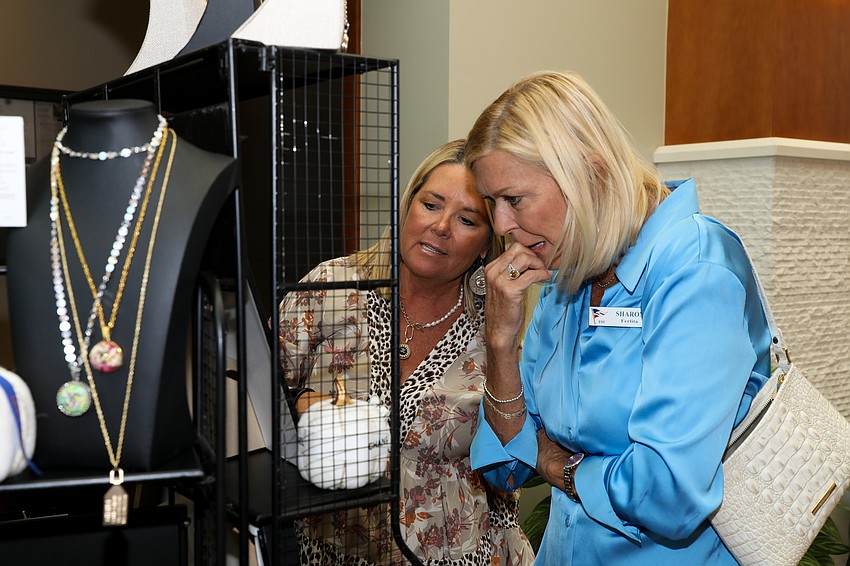 Betsy Tavernier shows Sharon Ferlita jewelry items for sale.