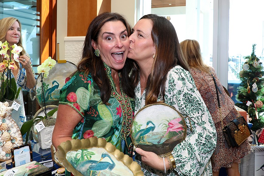 Potter Michelle Romine supplied the ceramic planters for each table and she gets surprise kiss from her sister Carolyn Nielubowicz.