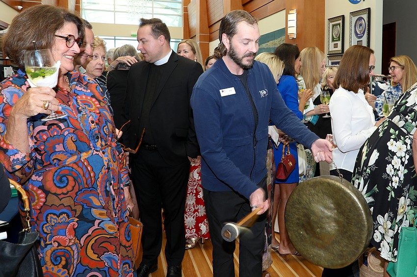 SYC's Kyle Bolenbaugh bangs a gong to let guests know that lunch is served.