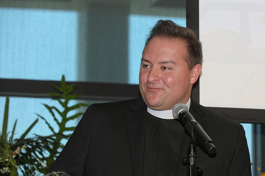 Church of the Redeemer's Father Waldon Mason Waldhauser gives the invocation before lunch.