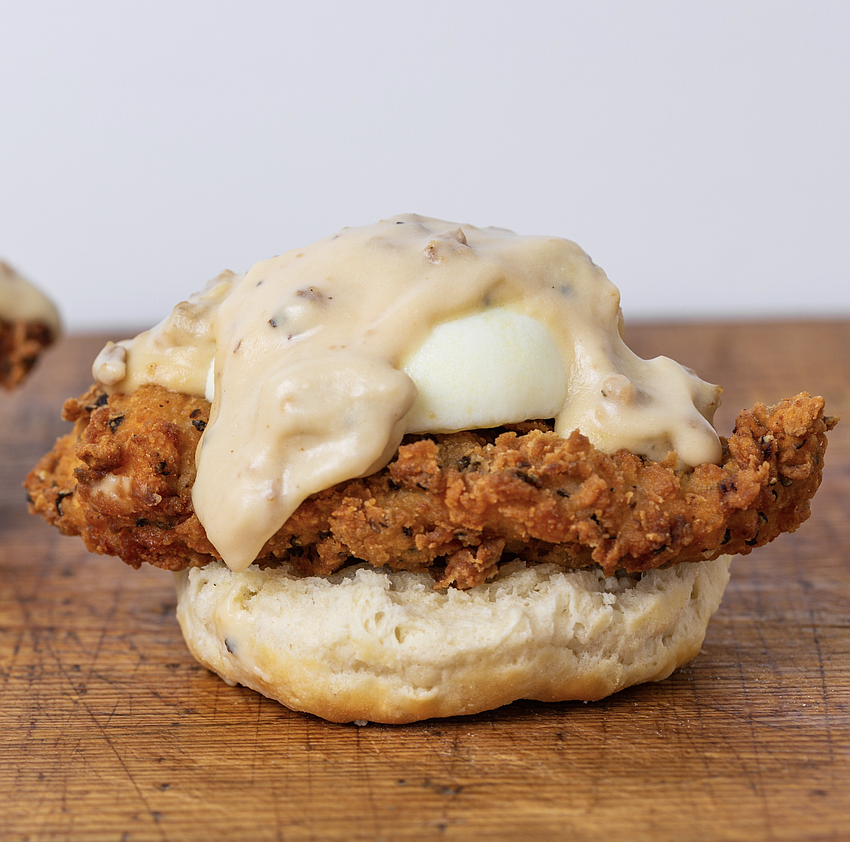 Southern friend Arnold from The Toasted Yolk: biscuit with hand-breaded chicken tenders, poached eggs and country sausage gravy.