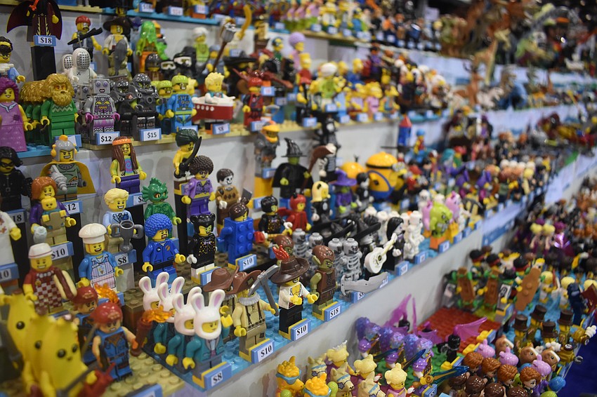 A shelf at the event is filled with Lego figures for sale.