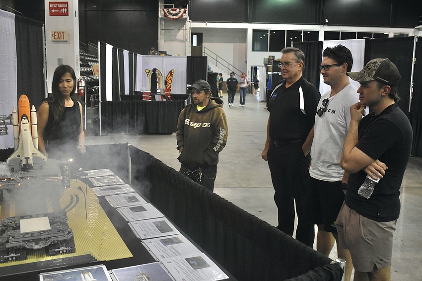 Lia Chan showcases the launch effect with her Lego rocket to Joe Spath, fairgrounds operator Rory Martin, Jordan Evans and Scott Martin.