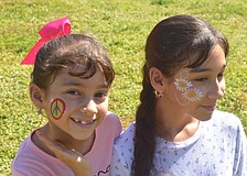 Lakewood Ranch sisters Mariapaz Ritter, 7 and Analia Ritter, 12, got their faces painted by Akiko Graphics at the at Greenbrook Adventure Park. Mariapaz chose a peace sign because "paz" the last part of her name means peace in Spanish and Analia chose daisies because they are her favorite flowers.