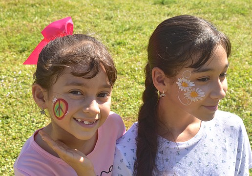Lakewood Ranch sisters Mariapaz Ritter, 7 and Analia Ritter, 12, got their faces painted by Akiko Graphics at the at Greenbrook Adventure Park. Mariapaz chose a peace sign because "paz" the last part of her name means peace in Spanish and Analia chose daisies because they are her favorite flowers.