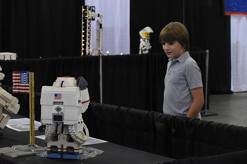 Rocky Worth, 10, looks at the space Legos on display.