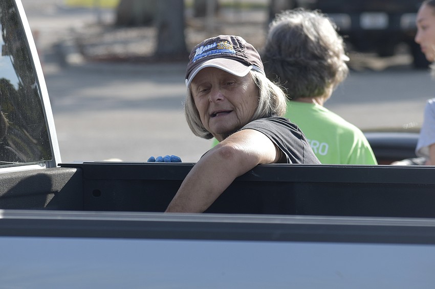 Olga Hanlon helps load an attendee's truck.