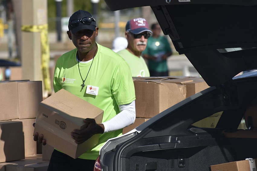 Aaron Walters and David Cohen help load the vehicles.