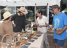 Miriam Cornell and James Garlanger of Bear Gully Creek Farms talk with Cornell's mother, Sharon Cornell, and Jim Sroka.