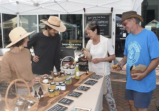 Miriam Cornell and James Garlanger of Bear Gully Creek Farms talk with Cornell's mother, Sharon Cornell, and Jim Sroka.