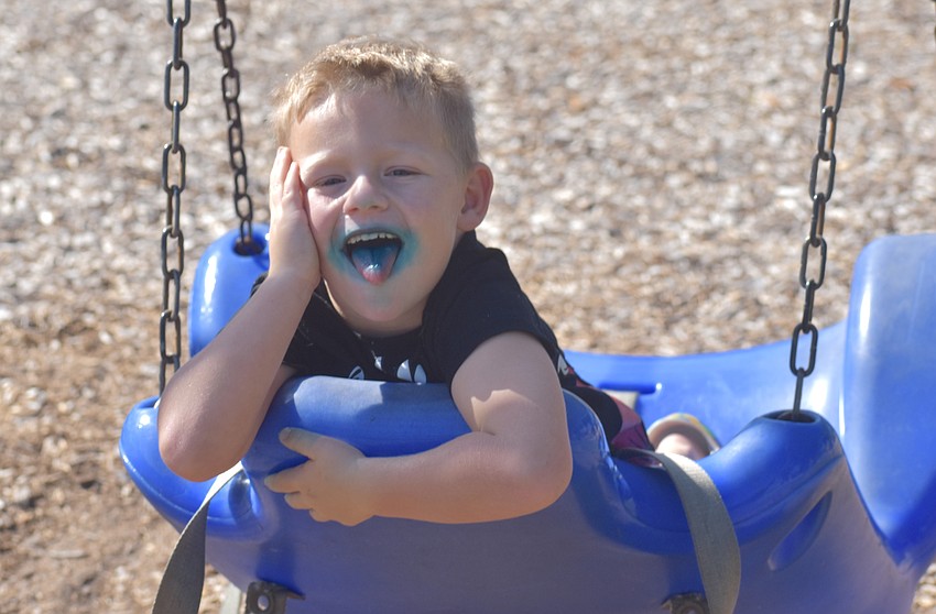 Lakewood Ranch resident Jaxson Raleigh takes some time to chill on the swing after enjoying a blueberry flavored Sonic popsicle from the Myrtle's Sweet Treats truck.