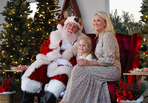 Alison and Eloise Fichner snap a photo with Santa Claus at Light Up Longboat on Nov. 22 at the Town Center Green.