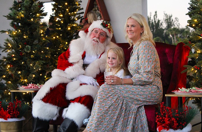 Alison and Eloise Fichner snap a photo with Santa Claus at Light Up Longboat on Nov. 22 at the Town Center Green.
