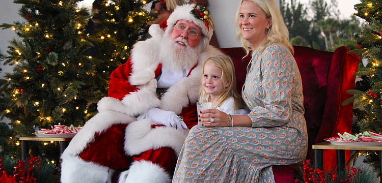 Alison and Eloise Fichner snap a photo with Santa Claus at Light Up Longboat on Nov. 22 at the Town Center Green.