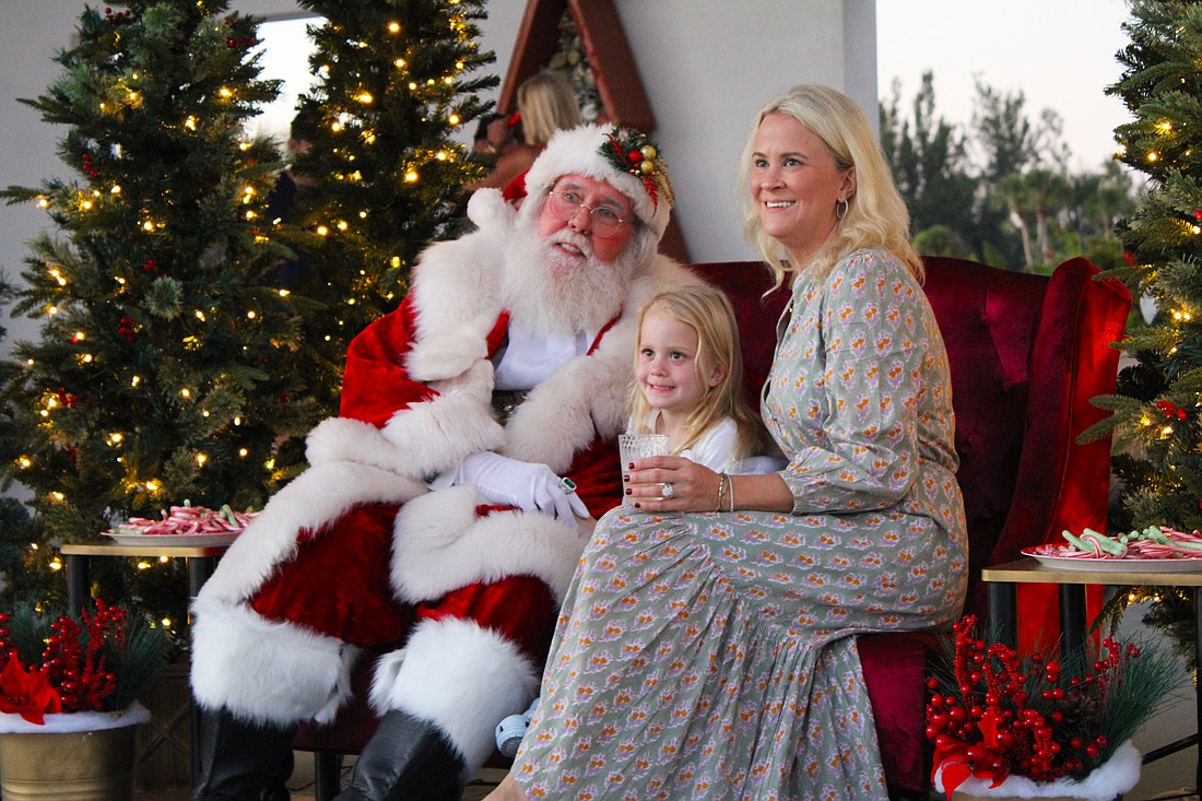 Alison and Eloise Fichner snap a photo with Santa Claus at Light Up Longboat on Nov. 22 at the Town Center Green.