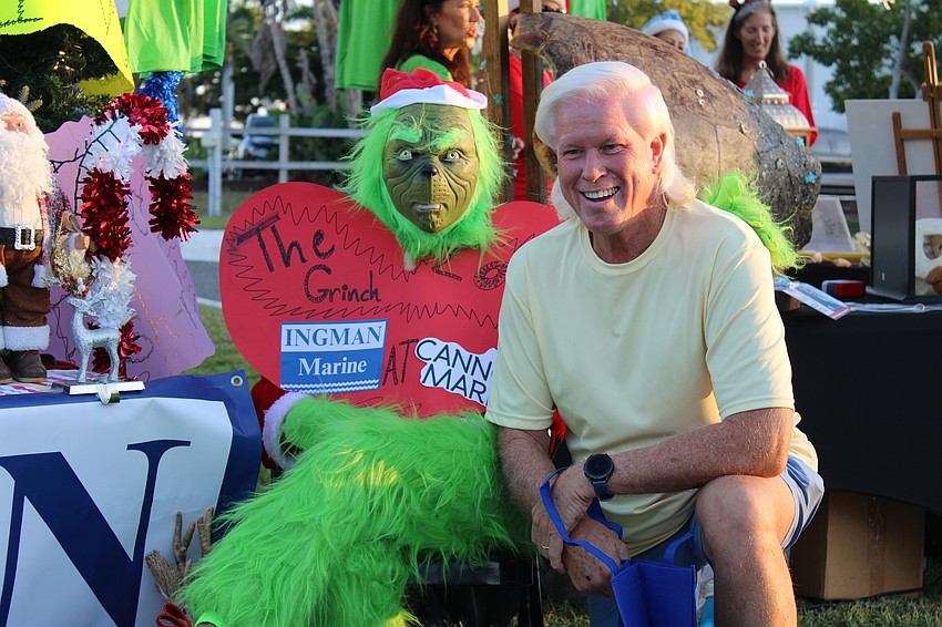Light Up Longboat attendee Tommy Rheinlander shows some youngsters that he's not afraid of the Grinch.