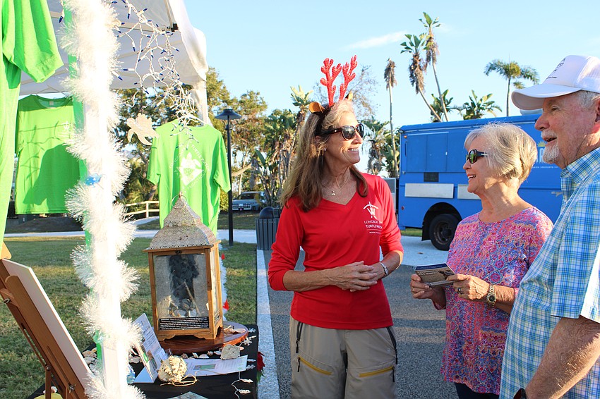 Cyndi Seamon, Longboat Key Turtle Watch vice president, chats with attendees at Light Up Longboat.