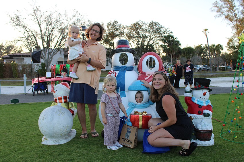 The Gowl family, including Victor, Andie, 5-year-old Selma, 1-year-old Noa and 2-year-old Judah explore the snowman display at Light Up Longboat.