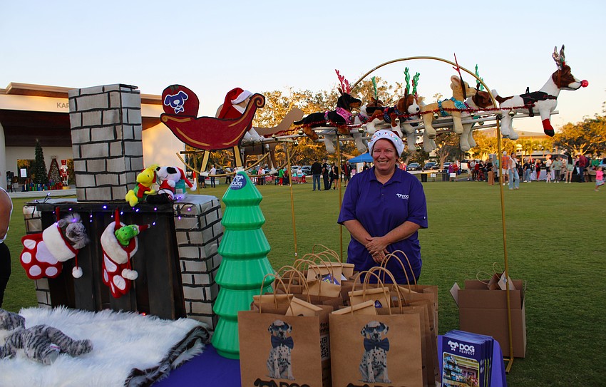 Karen Bedsole with Dog Perfect shows off the team's impressive holiday display at Light Up Longboat.