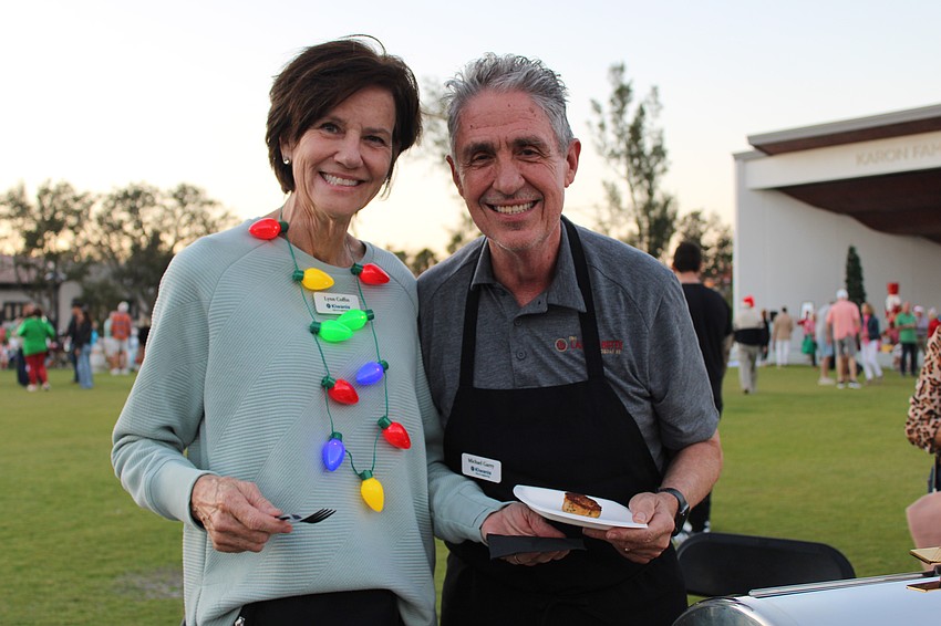 Lynn Armstrong Coffin and Michael Garey dish up crab cakes for attendees at Light Up Longboat.