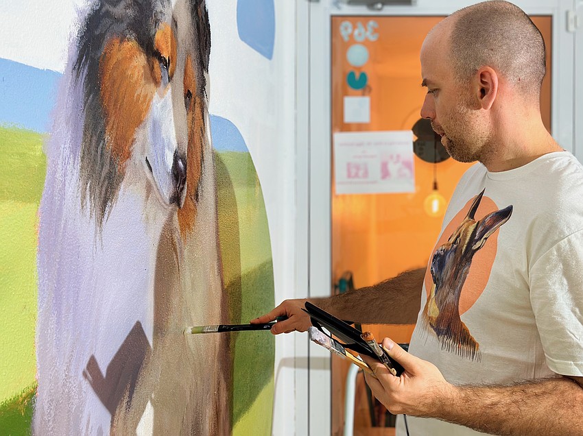 Muralist Ludmil Iliev adds the finishing touches to a portrait of Ziggy.