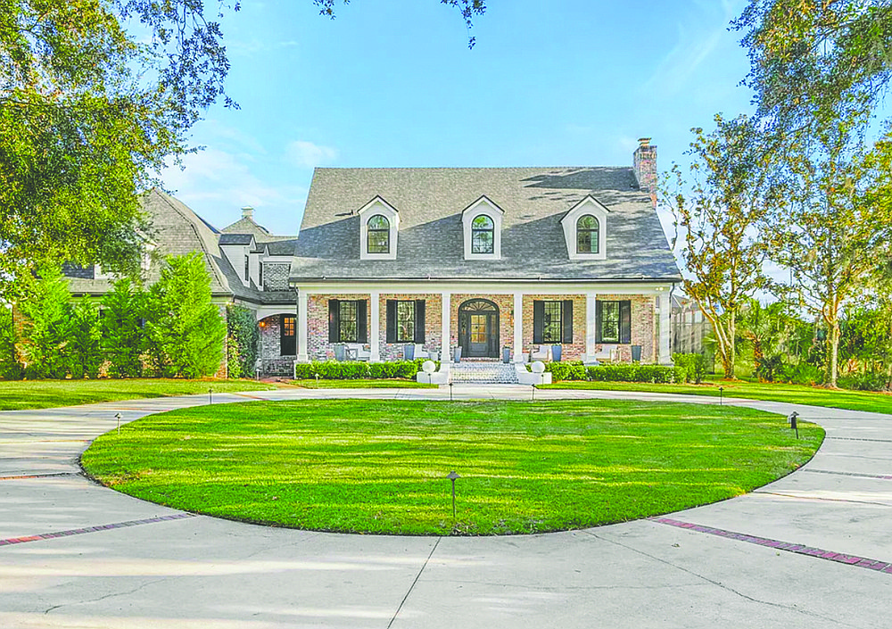 Marshfront two-story home features five bedrooms, six full and one half-bathrooms, porches, screened pool and three-car garage.