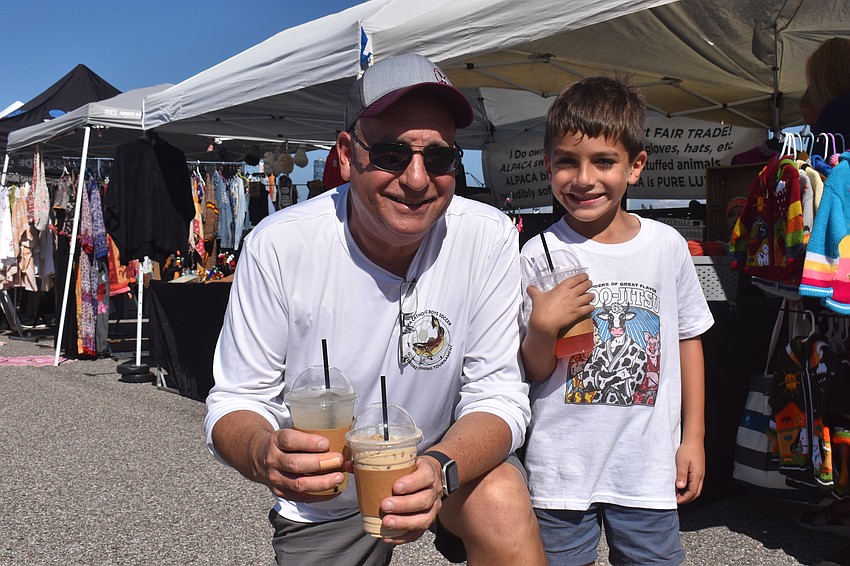 Bob Lees and Diego Whitman enjoy an espresso latte, lemonade and strawberry lemonade from Sip n Brew at The Market at Nathan Benderson Park.