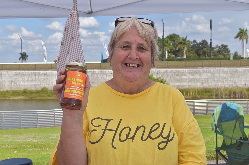 Cindy Edwards works the Sarasota Honey Company booth with lots of enthusiasm, making sure customers know what the booth offers with her Honey shirt.