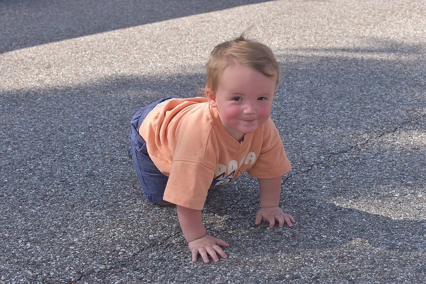 New Jersey's Lorenzo Cambria, 1, takes a break from shopping at the Market at Nathan Benderson Park to check out the concrete.