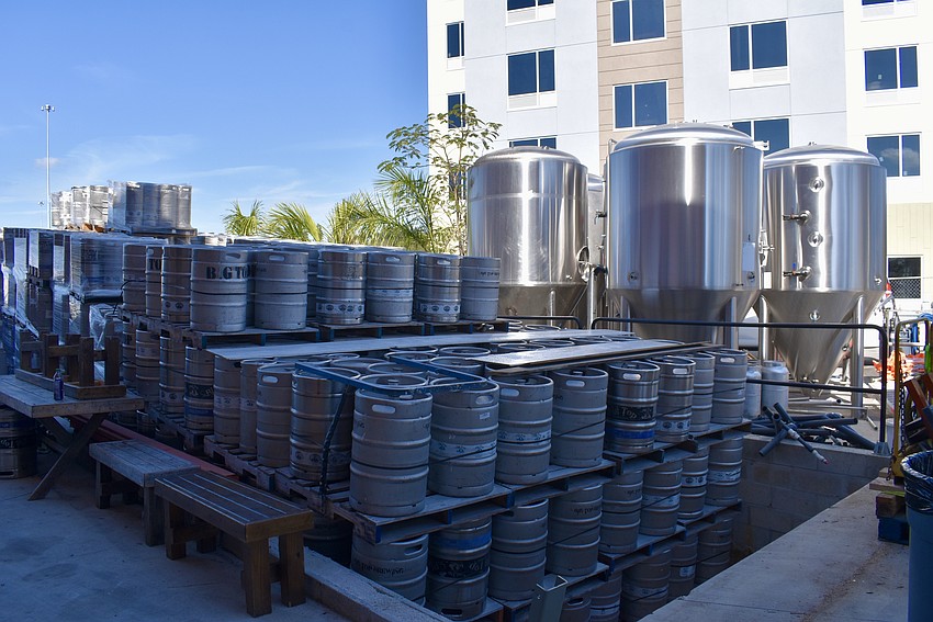 Pallets of empty kegs sit outside the brewery waiting to be filled. The tanks will be installed inside the new brew house.