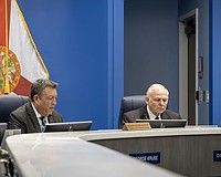 Commissioners George Kruse and Bob McCann are on opposite sides of the AAA High School vote. Kruse voted in favor of approving the site plan, and McCann voted to deny the site plan.