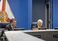 Commissioners George Kruse and Bob McCann are on opposite sides of the AAA High School vote. Kruse voted in favor of approving the site plan, and McCann voted to deny the site plan.