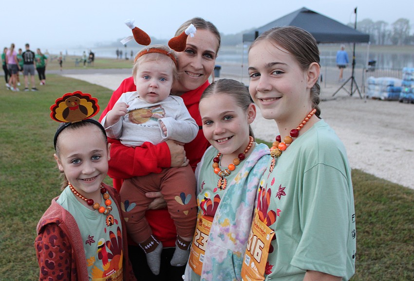 Sarasota's Brielle, 7, Barrett, 9 months, mom Katie, Adelaide, 9, and Hannah, 10, get ready to run in the Florida Turkey Trot. Katie Tennyson ran in last year's race even through she was pregnant.