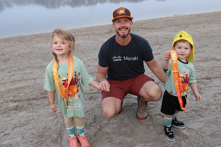 Alexandria Tomes, 3, her dad Daniel Tomes, and her brother, Fulton Tomes, 3, came to the Florida Turkey Trot at Nathan Benderson Park from Sanford, North Carolina, because they are trying to participate in a race in every state.