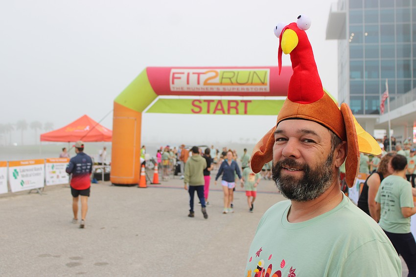 Sarasota's Chris Necev says he doesn't have any trouble running in the Florida Turkey Trot with a turkey on his head.